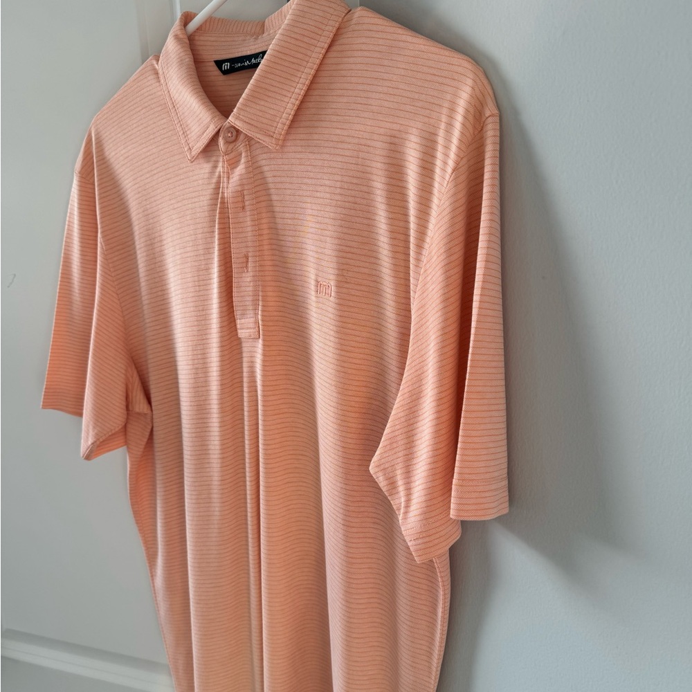 One men’s orange size medium Travis Mathew golf shirt